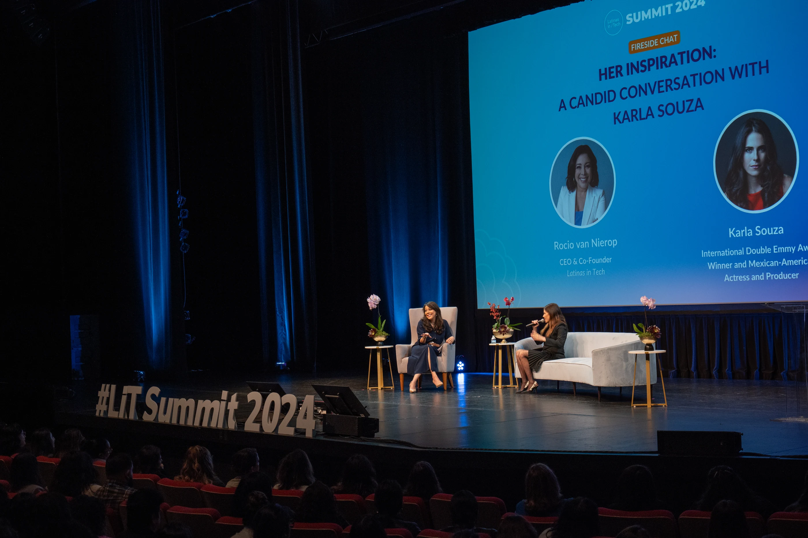 Two speakers onstage during a fireside chat at the Latinas in Tech Summit 2024