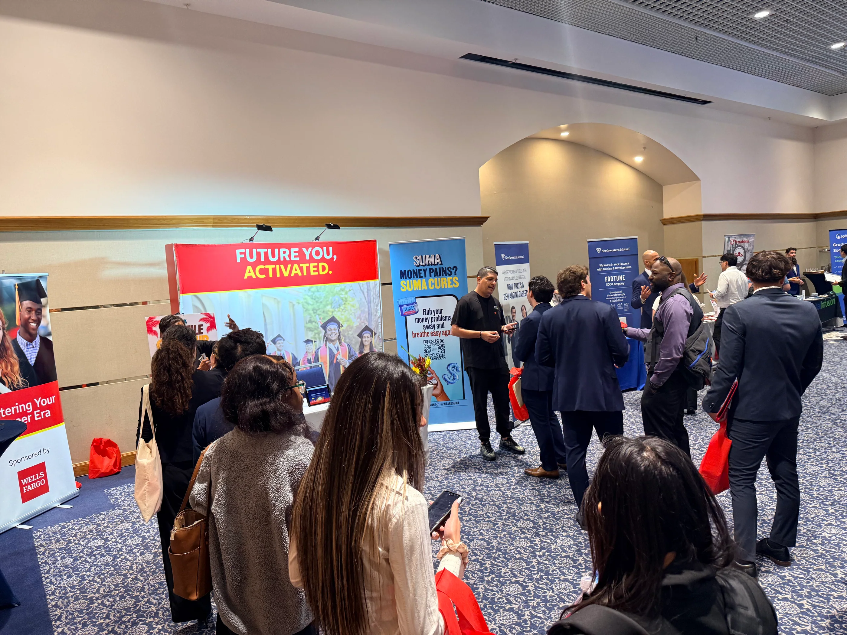 Guests engaging around the SUMA Wealth activation at Florida International University